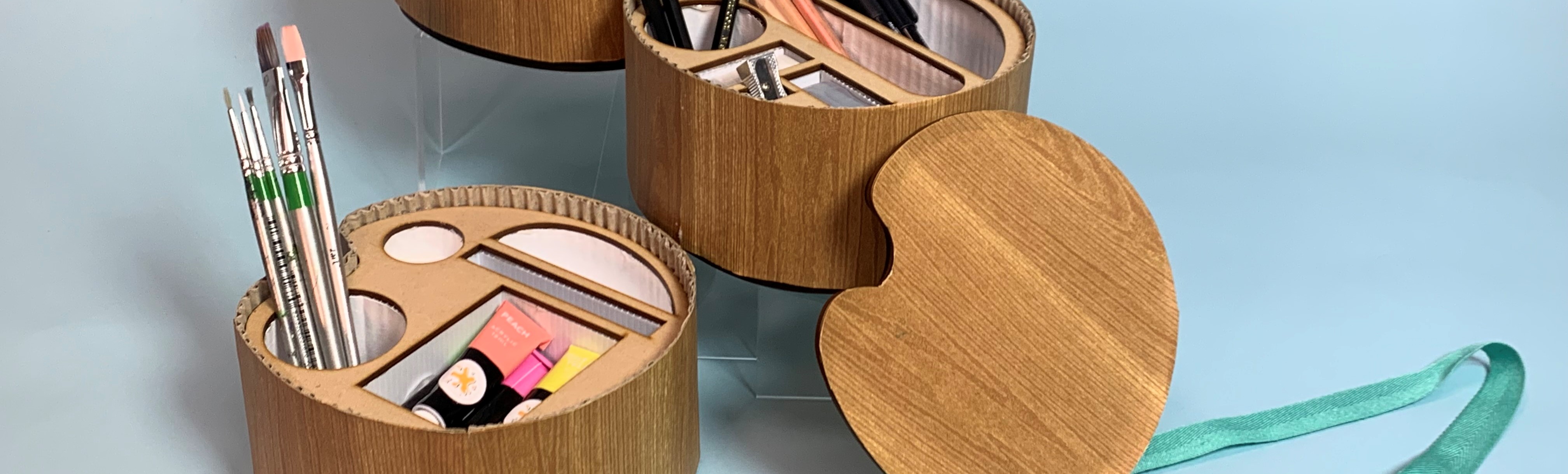 brown timber boxes in the shape of an artist palette