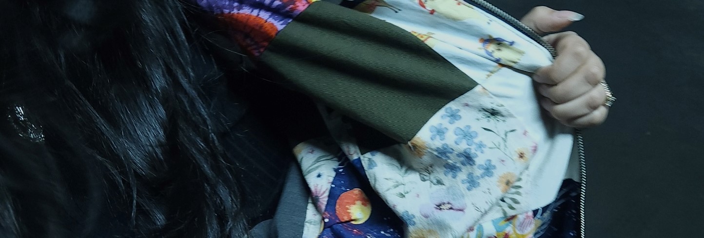 person opening jacket to reveal patchwork inside