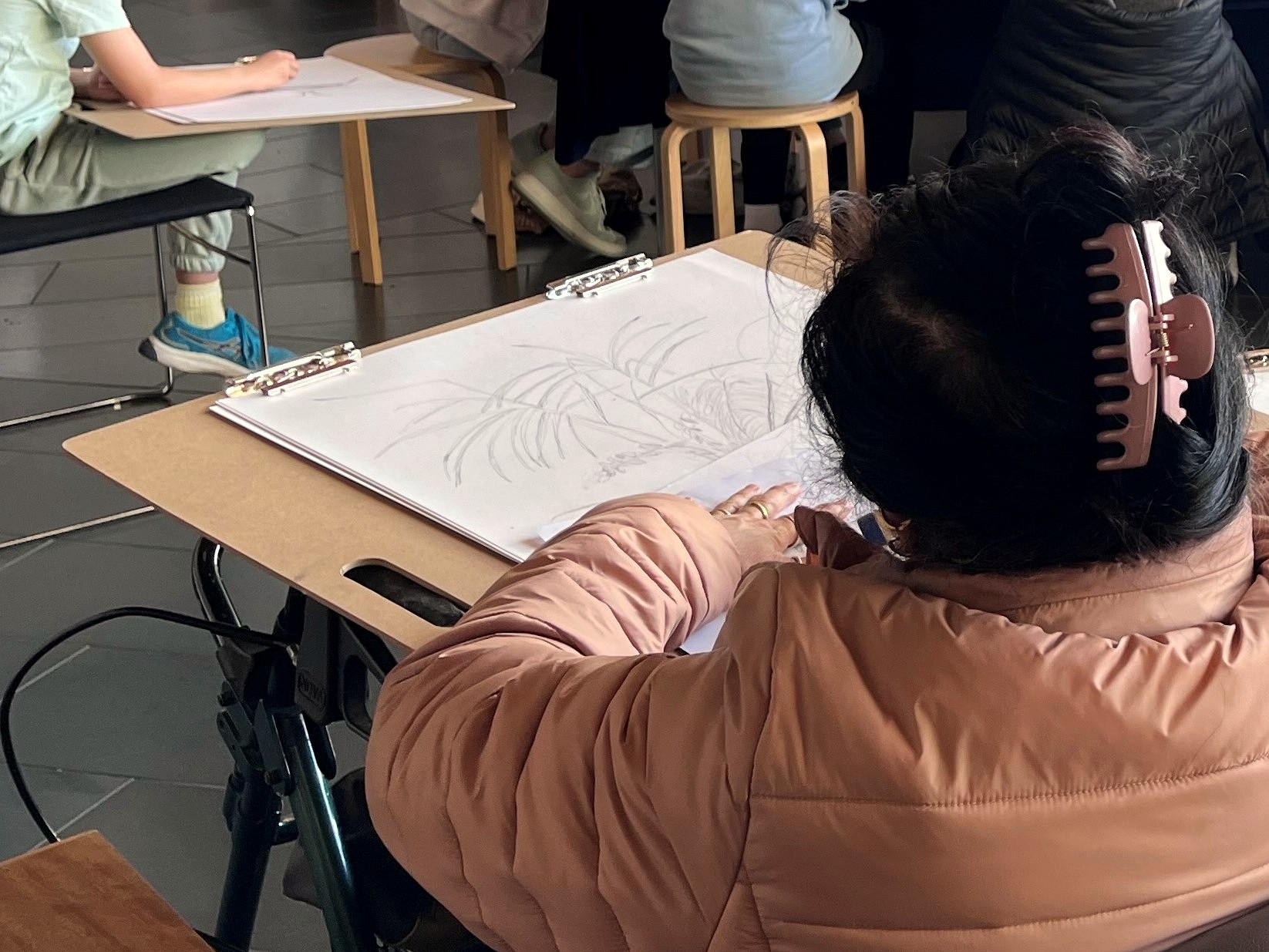 a person leaning a drawing board on their walker