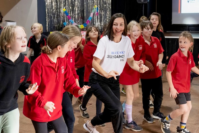 dancer Gulsen Ozer teaching dance with a group of children