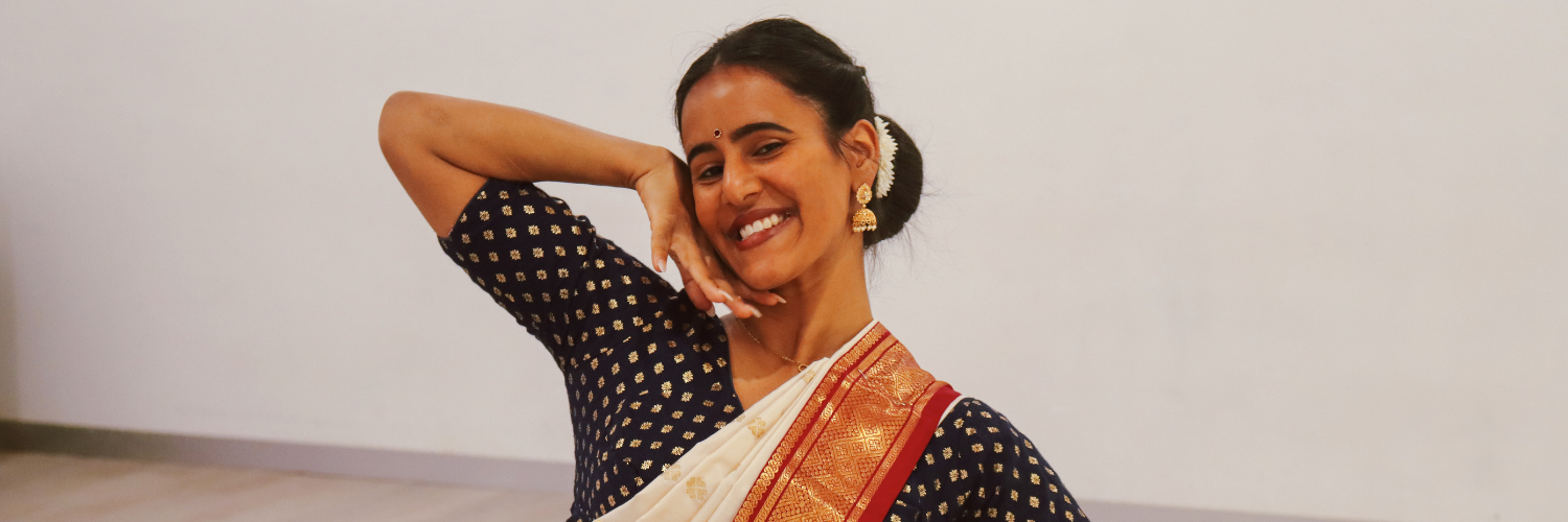 Young Indian lady wearing traditional clothing, posing happily for the camera