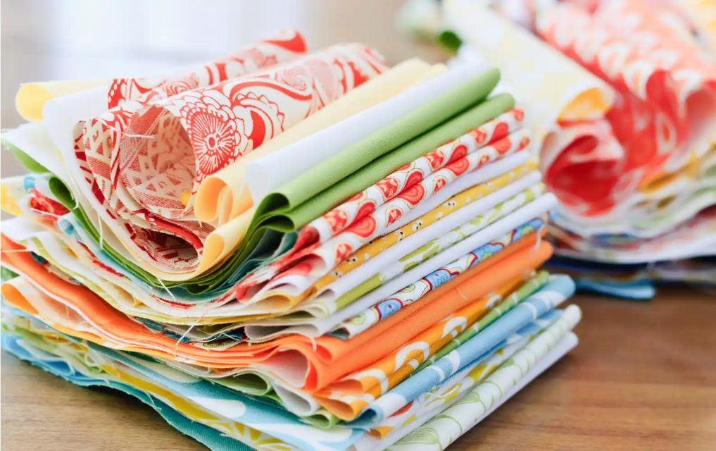 a stack of bright coloured fabrics