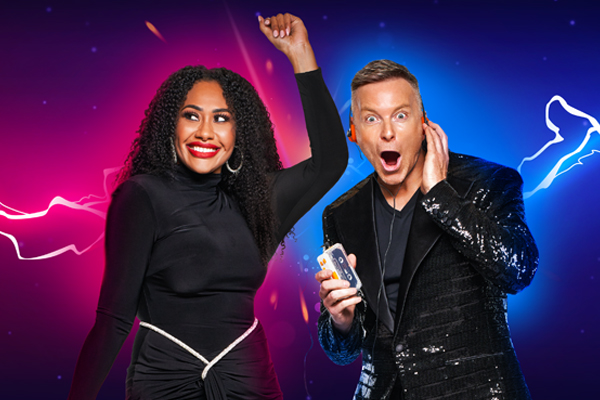 A woman in a black dress with a man in a suit dance, surrounded by electricity - Paulini & Tim Campbell - Electrifying 80s