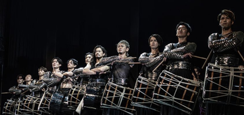 A line of drummers in costume