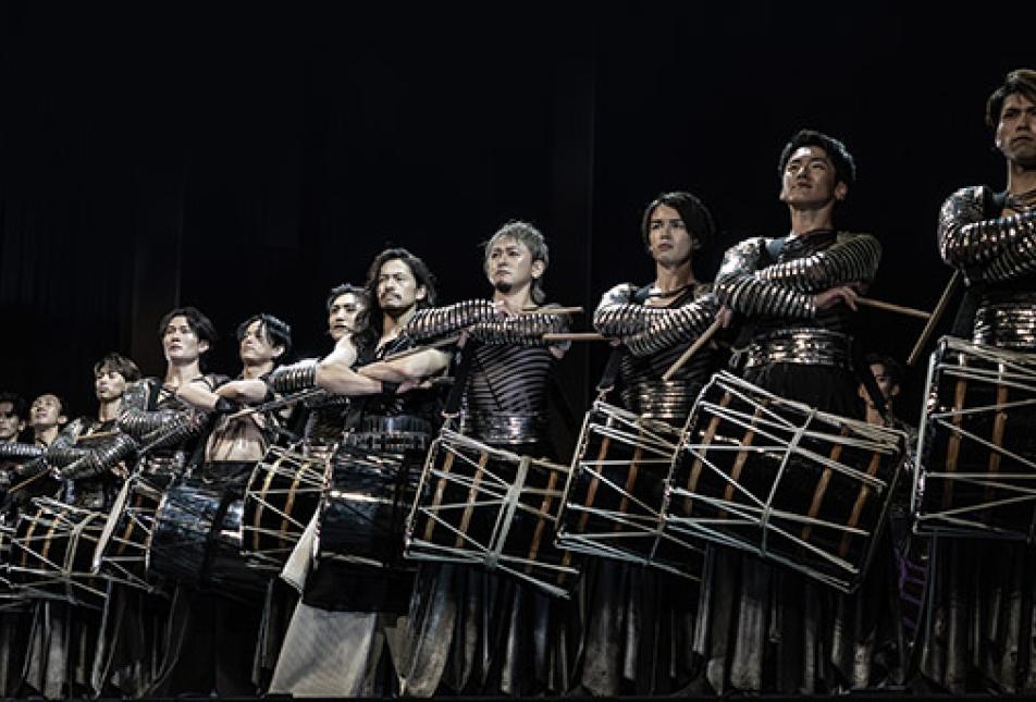 A line of drummers in costume