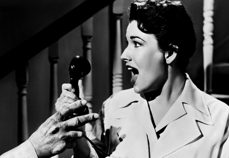A woman screams into a phone: A scene from Jack Arnold’s 1955 sci-fi horror classic Tarantula!