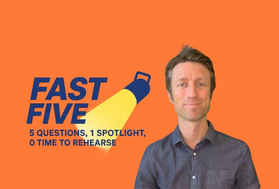 A portrait of a man in a grey shirt