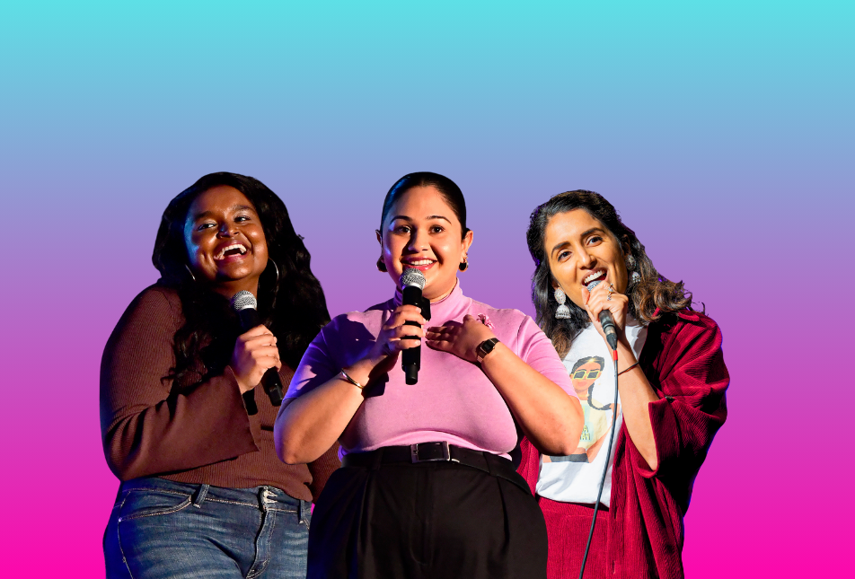 Three women comedians standing with microphones
