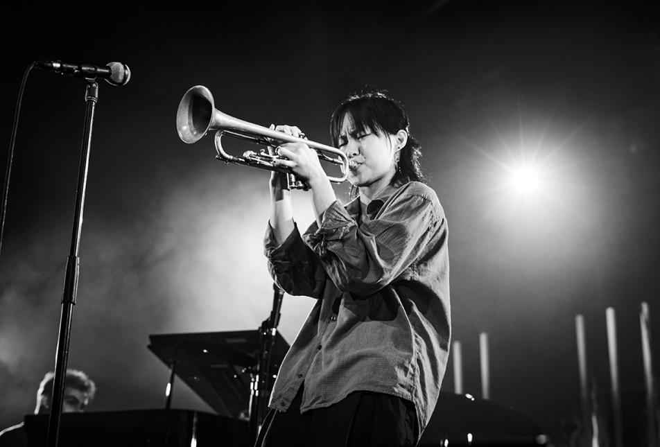 Musician Skylar Tang playing the trumpet - image is in black and white