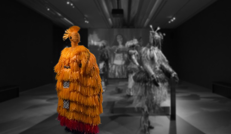 An exhibition display featuring a group of mannequins dressed in outfits by the Pacific Sisters.