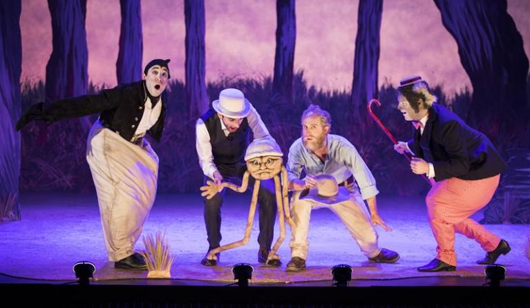 Four men on stage with a puppet - a scene from The Magic Pudding - The Opera