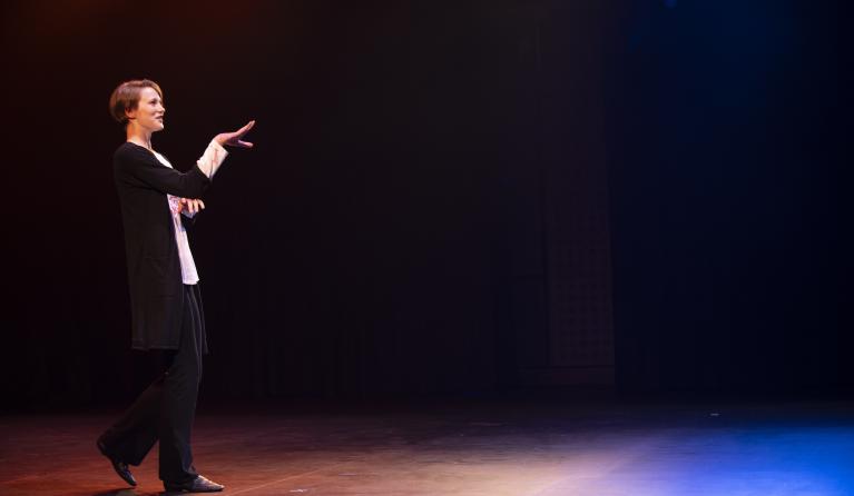 Young person performing theatre on stage