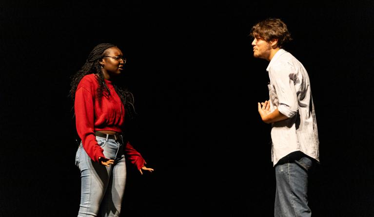 Two young actors performing on stage 