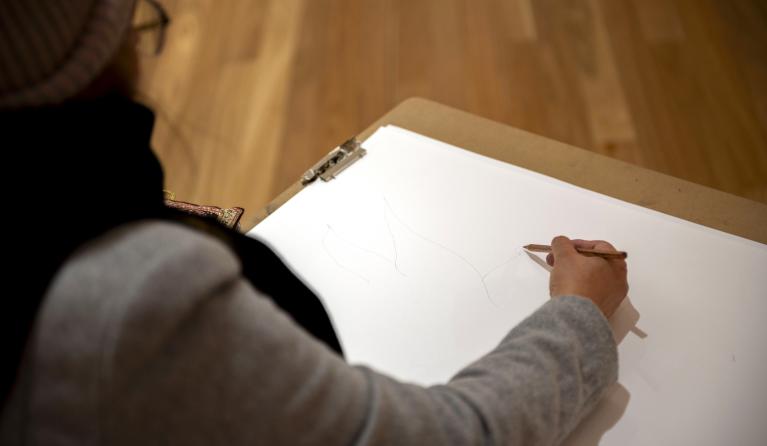 person sketching in the gallery