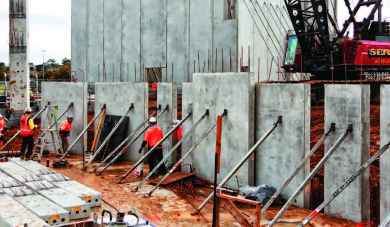 Theatre walls being erected in the foreground and studio walls standing tall in the background.