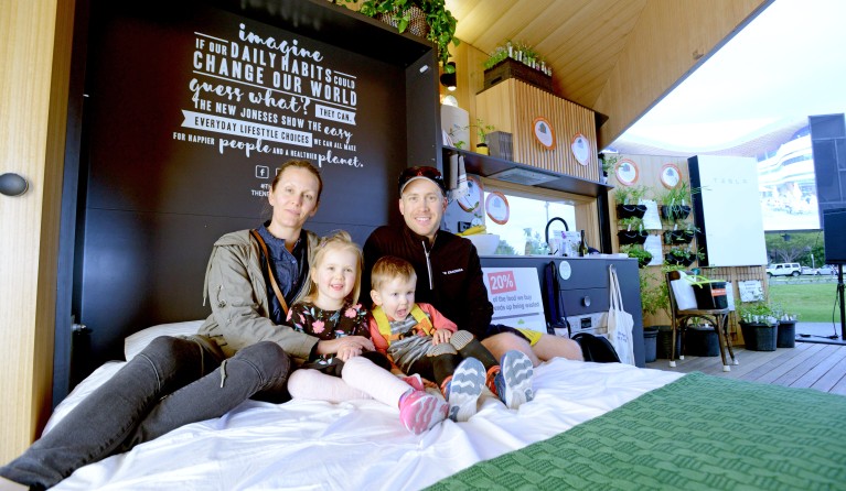 A local fam checking out how comfy the tiny house bed it!