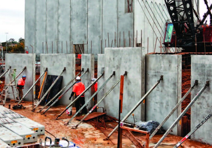 Theatre walls being erected in the foreground and studio walls standing tall in the background.