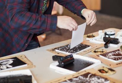 person doing lino printing